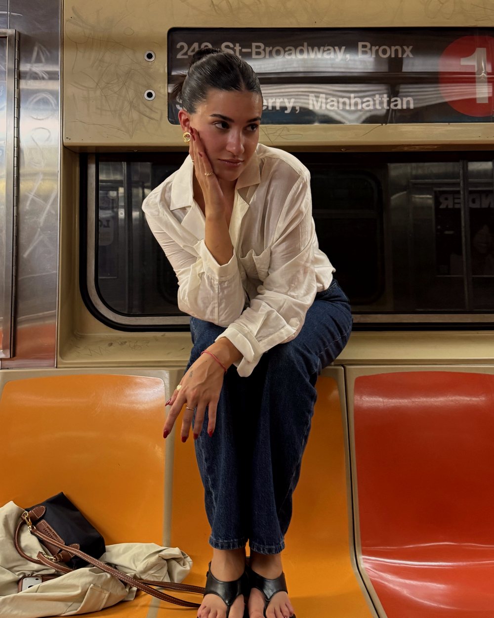 Sol Martinez sitting on a New York subway train